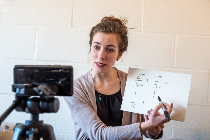 Young teacher using internet to remotely teach