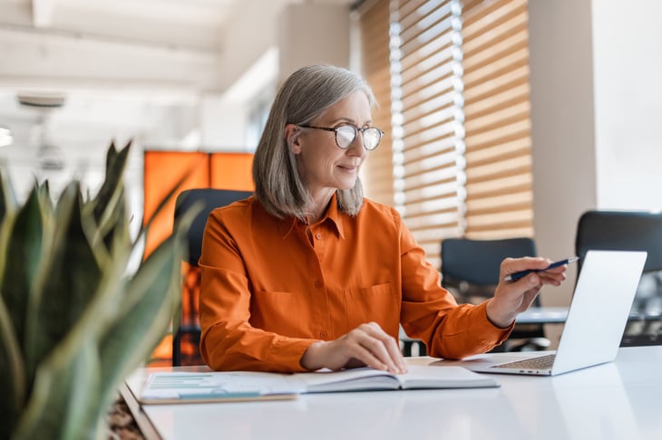 Older woman working in office.