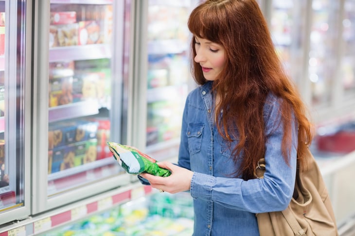 woman shopping for frozen vegetables veggies